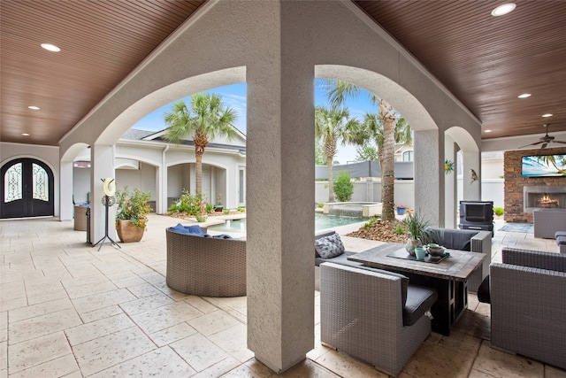 39 New Oak Trl, Humble, TX 77346 - view of patio with ceiling fan, an outdoor living space with a fireplace, french doors, and a pool with connected hot tub