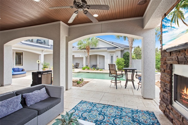 39 New Oak Trl, Humble, TX 77346 - view of patio / terrace with ceiling fan, an outdoor pool, and an outdoor living space with a fireplace