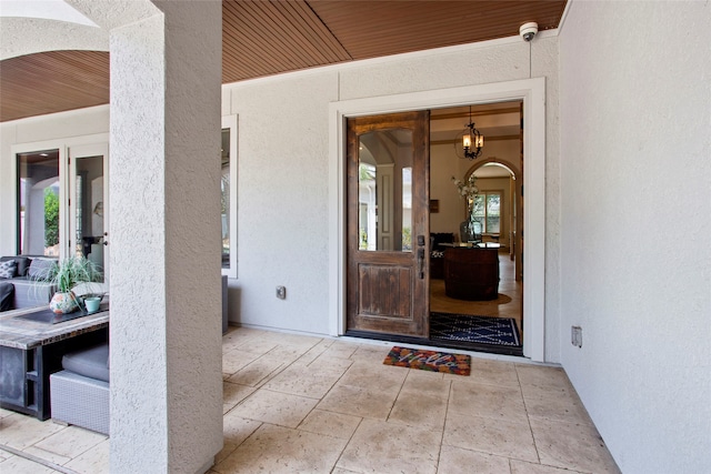 39 New Oak Trl, Humble, TX 77346 - view of exterior entry with stucco siding and a security system