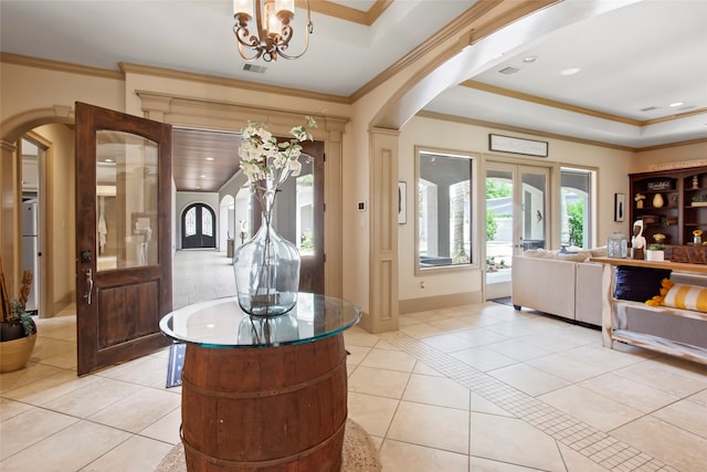 39 New Oak Trl, Humble, TX 77346 - entrance foyer featuring arched walkways, light tile patterned floors, crown molding, a chandelier, and a raised ceiling
