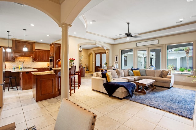 39 New Oak Trl, Humble, TX 77346 - living room featuring arched walkways, light tile patterned floors, ceiling fan, recessed lighting, and ornate columns