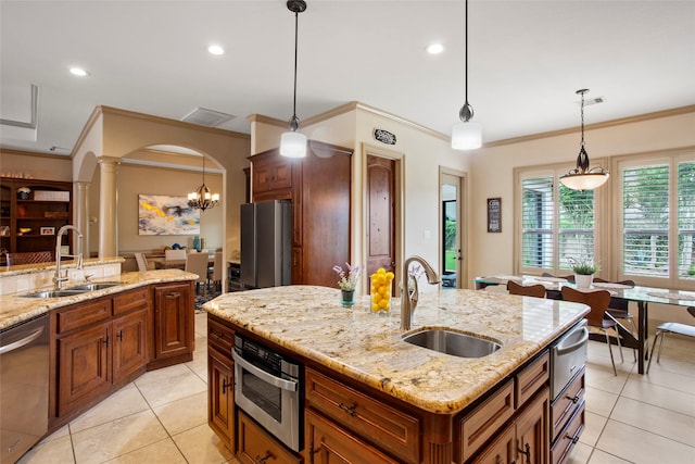 39 New Oak Trl, Humble, TX 77346 - kitchen featuring a sink, appliances with stainless steel finishes, a warming drawer, ornamental molding, and brown cabinets
