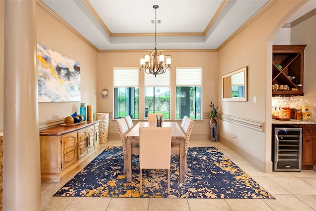 39 New Oak Trl, Humble, TX 77346 - dining area with beverage cooler, bar, crown molding, a raised ceiling, and a chandelier