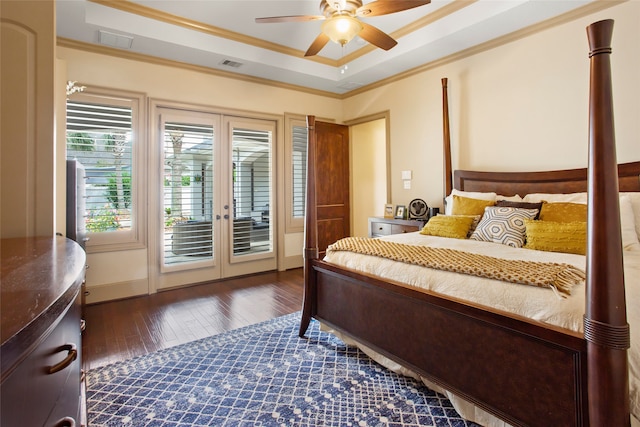 39 New Oak Trl, Humble, TX 77346 - bedroom featuring french doors, access to outside, dark wood-style flooring, a tray ceiling, and ornamental molding