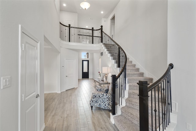 1711 Country Air Ln, Missouri City, TX 77459 - foyer entrance with a high ceiling, stairs, wood finished floors, baseboards, and recessed lighting