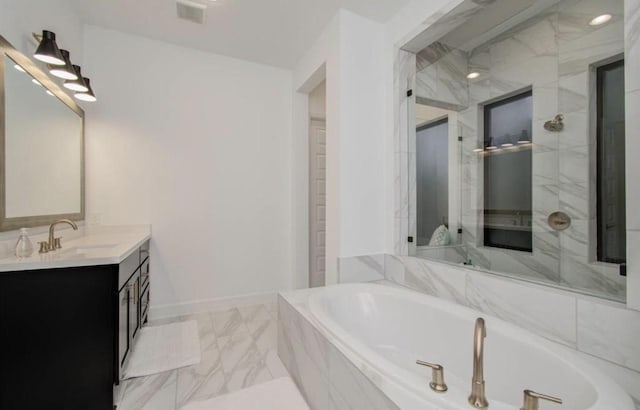8911 Orchard Cv, Missouri City, TX 77459 - bathroom featuring a garden tub, a stall shower, marble finish flooring, vanity, and baseboards