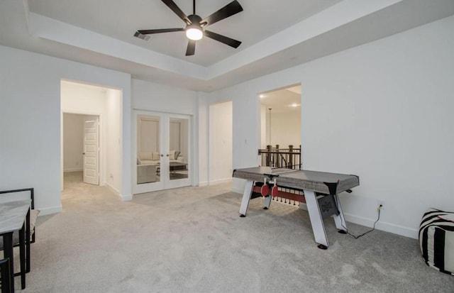 8911 Orchard Cv, Missouri City, TX 77459 - office featuring ceiling fan, french doors, a raised ceiling, baseboards, and light colored carpet