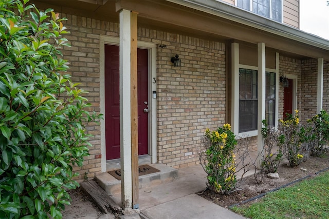 11404 Walnut Ridge Dv Unit 103, Austin, TX 78753 - view of exterior entry with brick siding and a porch