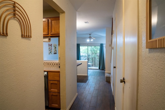 11404 Walnut Ridge Dv Unit 103, Austin, TX 78753 - hall featuring dark wood-type flooring, baseboards, and a textured wall