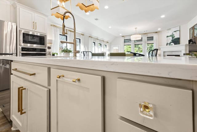 7918 Silver Grove Dr, Magnolia, TX 77354 - kitchen with oven, built in microwave, plenty of natural light, recessed lighting, and white cabinetry