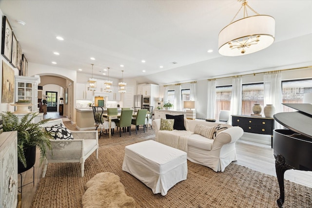 7918 Silver Grove Dr, Magnolia, TX 77354 - living room with arched walkways, a chandelier, and recessed lighting