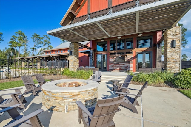 7918 Silver Grove Dr, Magnolia, TX 77354 - view of patio featuring an outdoor fire pit, fence, and french doors