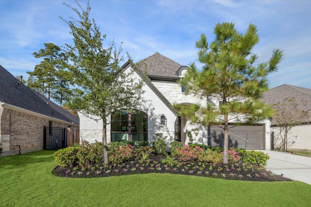 7918 Silver Grove Dr, Magnolia, TX 77354 - french country inspired facade featuring concrete driveway, brick siding, and an attached garage