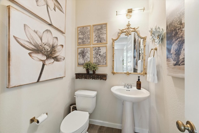 7918 Silver Grove Dr, Magnolia, TX 77354 - half bathroom featuring toilet, wood finished floors, and baseboards