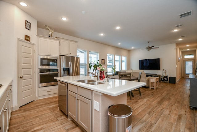 2543 Summer Peach St, Katy, TX 77494 - kitchen featuring stainless steel appliances, light wood-type flooring, a sink, open floor plan, and recessed lighting