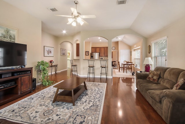 13614 Brighton Park Dr, Houston, TX 77044 - living room with arched walkways, ceiling fan, dark wood-type flooring, lofted ceiling, and baseboards