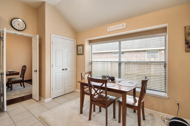 13614 Brighton Park Dr, Houston, TX 77044 - dining space with plenty of natural light, vaulted ceiling, light tile patterned floors, baseboards, and a desk