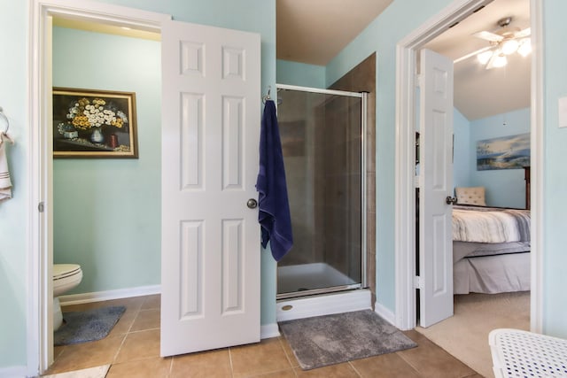 13614 Brighton Park Dr, Houston, TX 77044 - ensuite bathroom with a stall shower, a ceiling fan, tile patterned floors, toilet, and baseboards