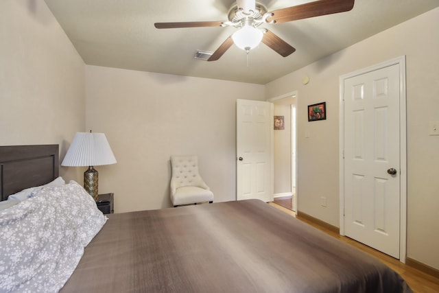 13614 Brighton Park Dr, Houston, TX 77044 - bedroom featuring wood finished floors, baseboards, and a ceiling fan