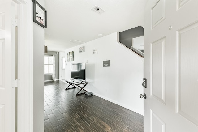 foyer entrance featuring baseboards and dark wood-style flooring