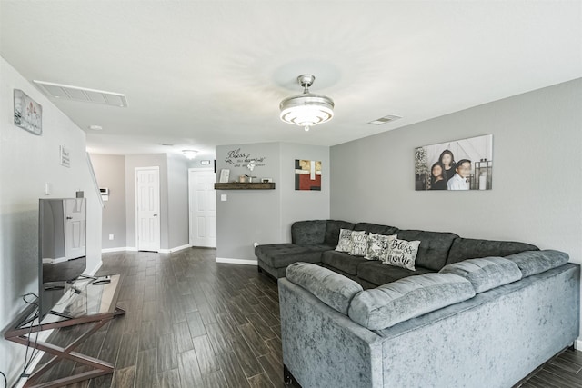 living area featuring dark wood finished floors and baseboards