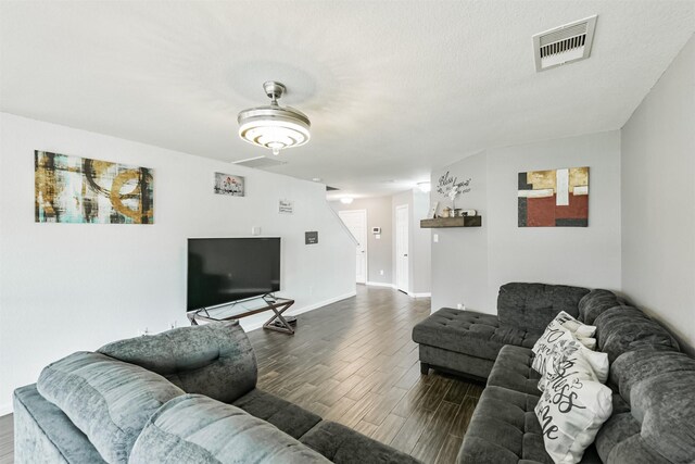 living room featuring dark wood finished floors and baseboards