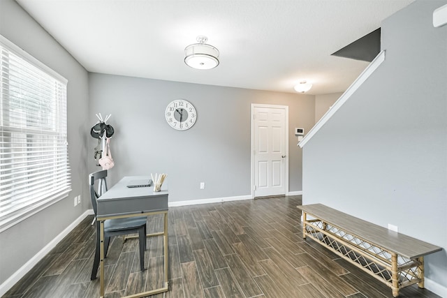 office space with dark wood finished floors and baseboards