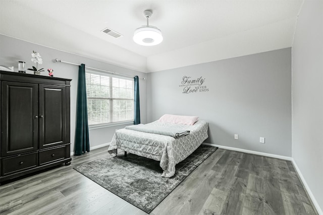 bedroom featuring light wood-style floors and baseboards