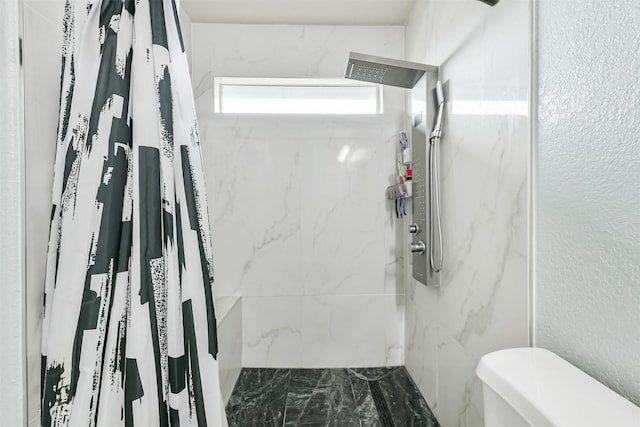 bathroom featuring a marble finish shower, toilet, and marble finish flooring