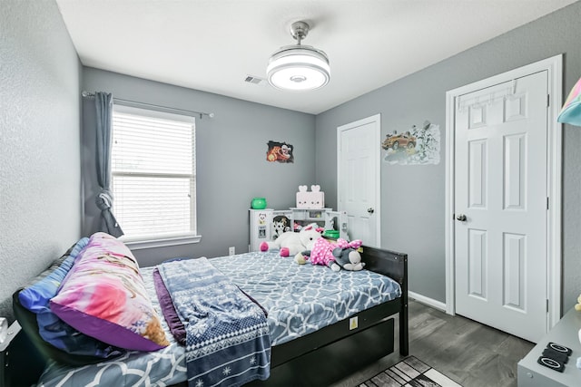 bedroom with dark wood-style flooring