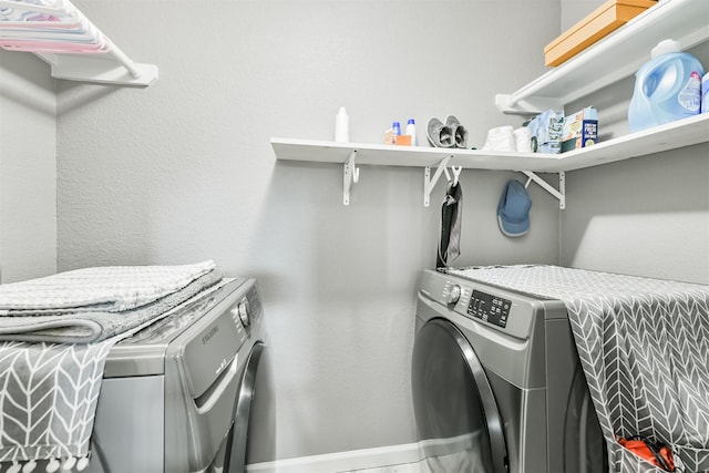 washroom featuring washer and clothes dryer