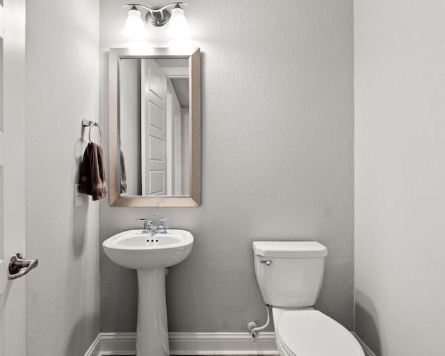 half bathroom featuring toilet