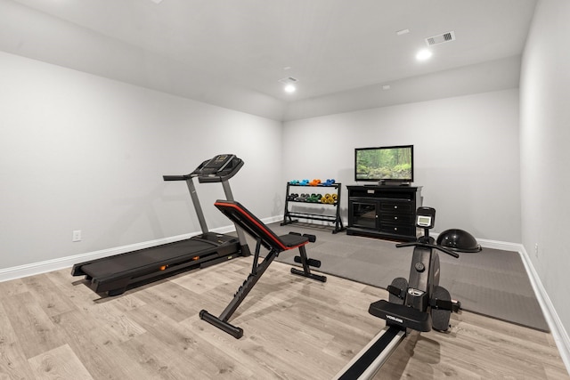workout area with wood finished floors and baseboards