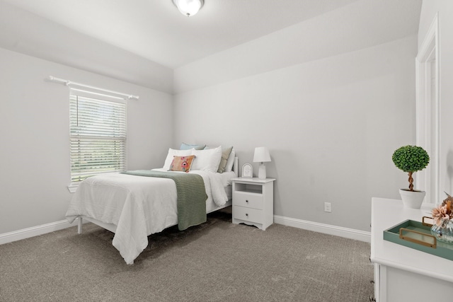 bedroom featuring light carpet, baseboards, and vaulted ceiling