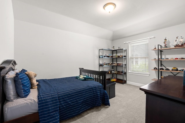 bedroom with light carpet and baseboards
