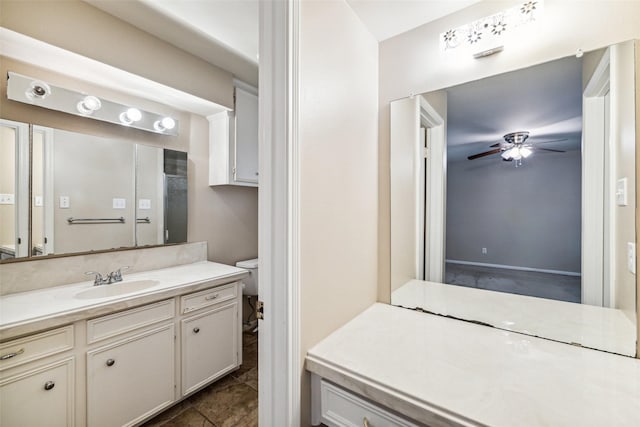 bathroom featuring ceiling fan, vanity, and toilet