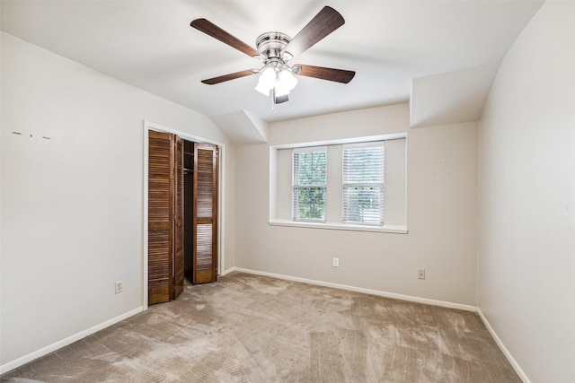 unfurnished bedroom featuring carpet flooring, a closet, baseboards, and a ceiling fan