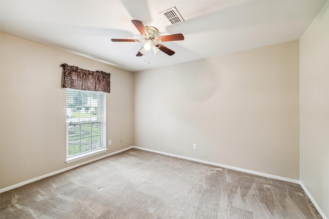 unfurnished room featuring carpet floors, baseboards, and ceiling fan