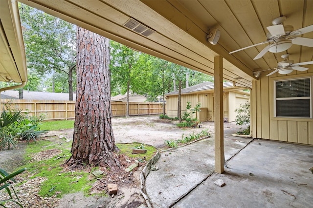 view of patio with ceiling fan and fence