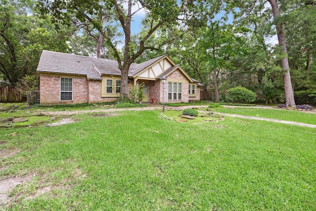 english style home featuring brick siding