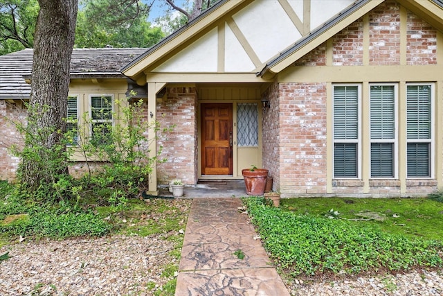 property entrance featuring brick siding and stucco siding