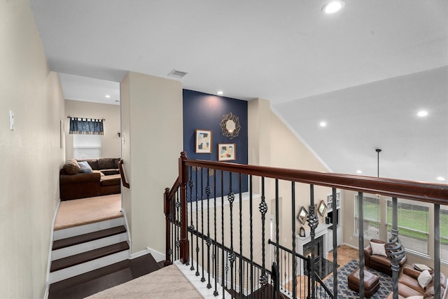hallway with recessed lighting, baseboards, and an upstairs landing