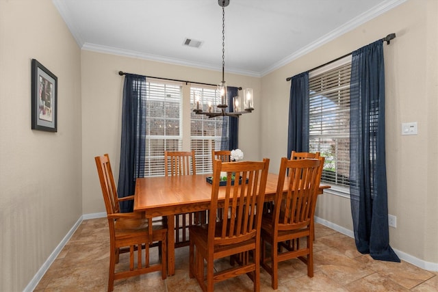 dining area with a chandelier, ornamental molding, and baseboards