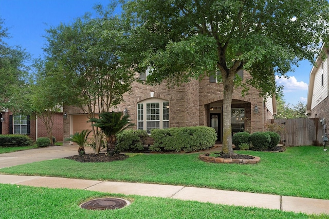 view of front of property with driveway, brick siding, and an attached garage
