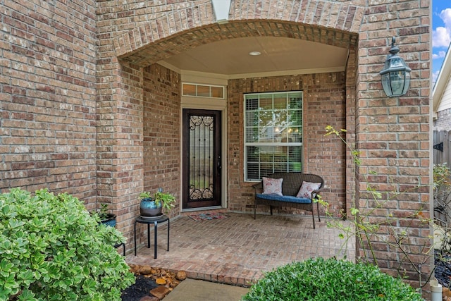 property entrance featuring brick siding
