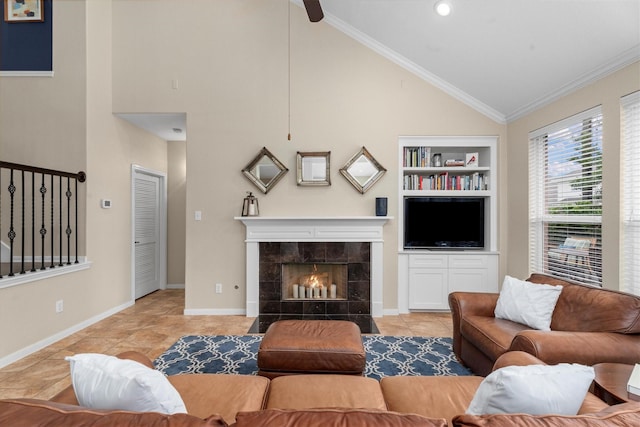 tiled living area with built in features, high vaulted ceiling, baseboards, a tile fireplace, and ornamental molding