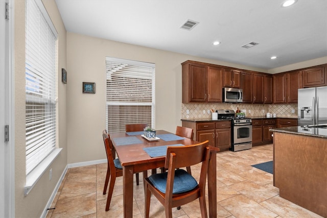 kitchen featuring stainless steel appliances, tasteful backsplash, plenty of natural light, and recessed lighting