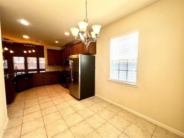 13842 Evansdale Ln, Houston, TX 77083 - kitchen featuring black refrigerator with ice dispenser, a chandelier, plenty of natural light, recessed lighting, and pendant lighting