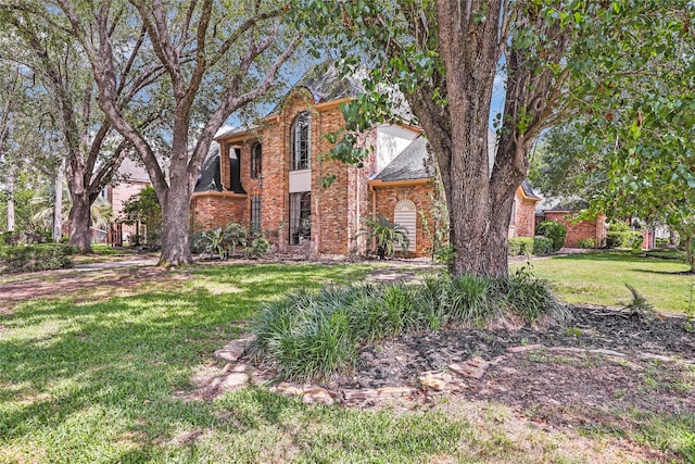 6319 Wimbledon Villas Dr, Spring, TX 77379 - traditional-style house with a front lawn and brick siding