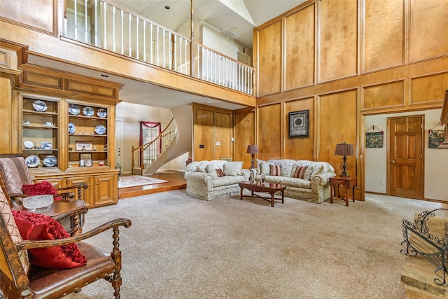 6319 Wimbledon Villas Dr, Spring, TX 77379 - living room with carpet floors, a towering ceiling, stairs, and baseboards